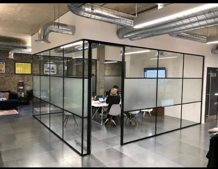Minimalist glass partition in a London studio
